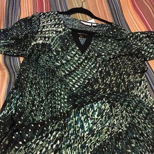 Susan Grover long sleeve, jewel at the neckline.